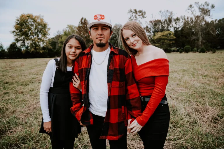 1536x1024.jpeg Meredith posing outdoors with her husband and daughter